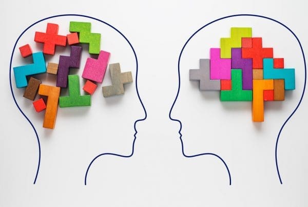 Outline of two brains with coloured blocks to signify the brains
